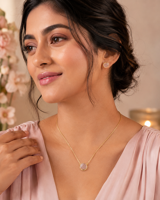 RAVINAAZ Elina Rose Quartz Pendant Set with gold-toned pendant necklace and matching rose quartz stud earrings styled on model