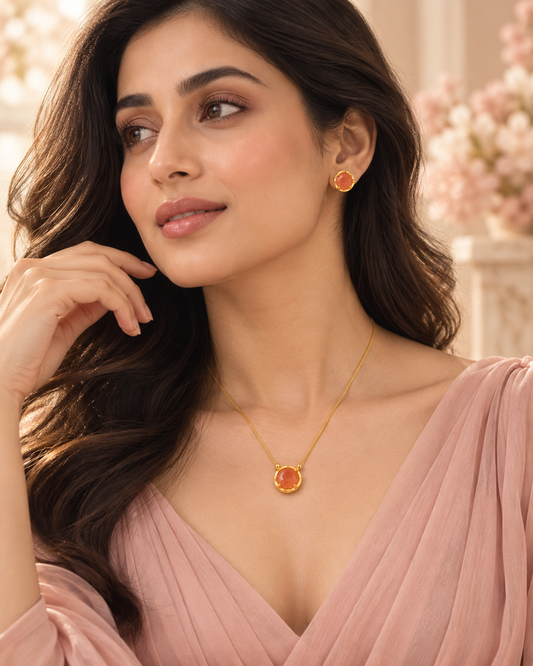 RAVINAAZ Elina Carnelian Pendant Set styled on model, featuring a gold-toned necklace with a round carnelian pendant and matching stud earrings